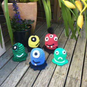 Crochet toys little monsters in different colours and patterns