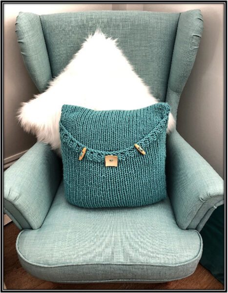 Knitted luxury pillow pattern soft teal in scandinavian chair